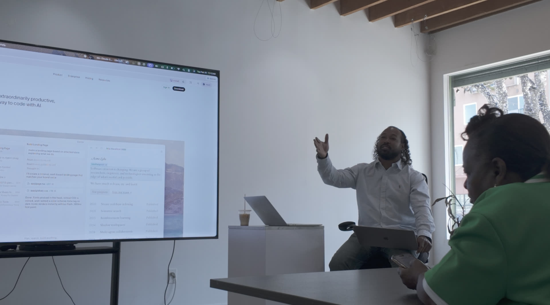 Madison Shockley III mid-gesture during a workshop session, walking students through a project on the projector